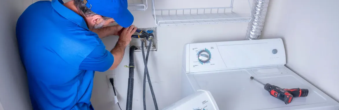 man-working-on-washer-and-dryer